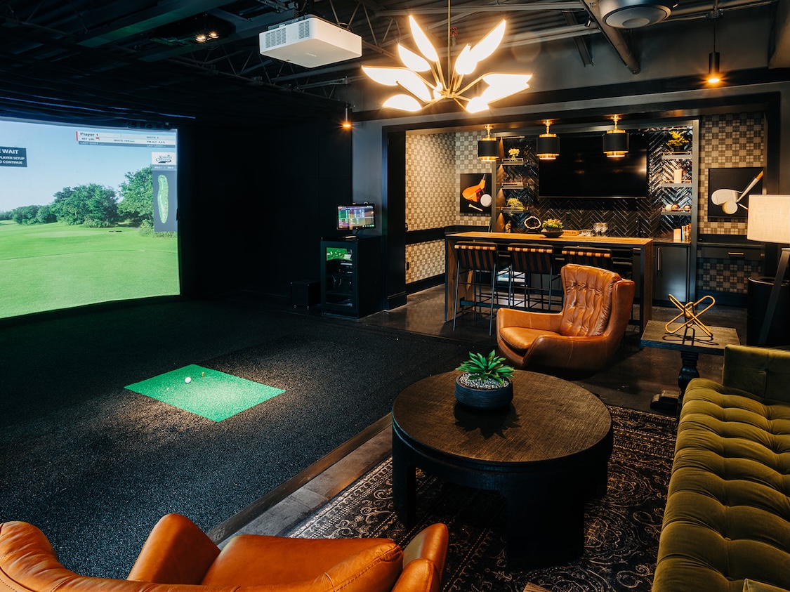 a room with a golf simulator 