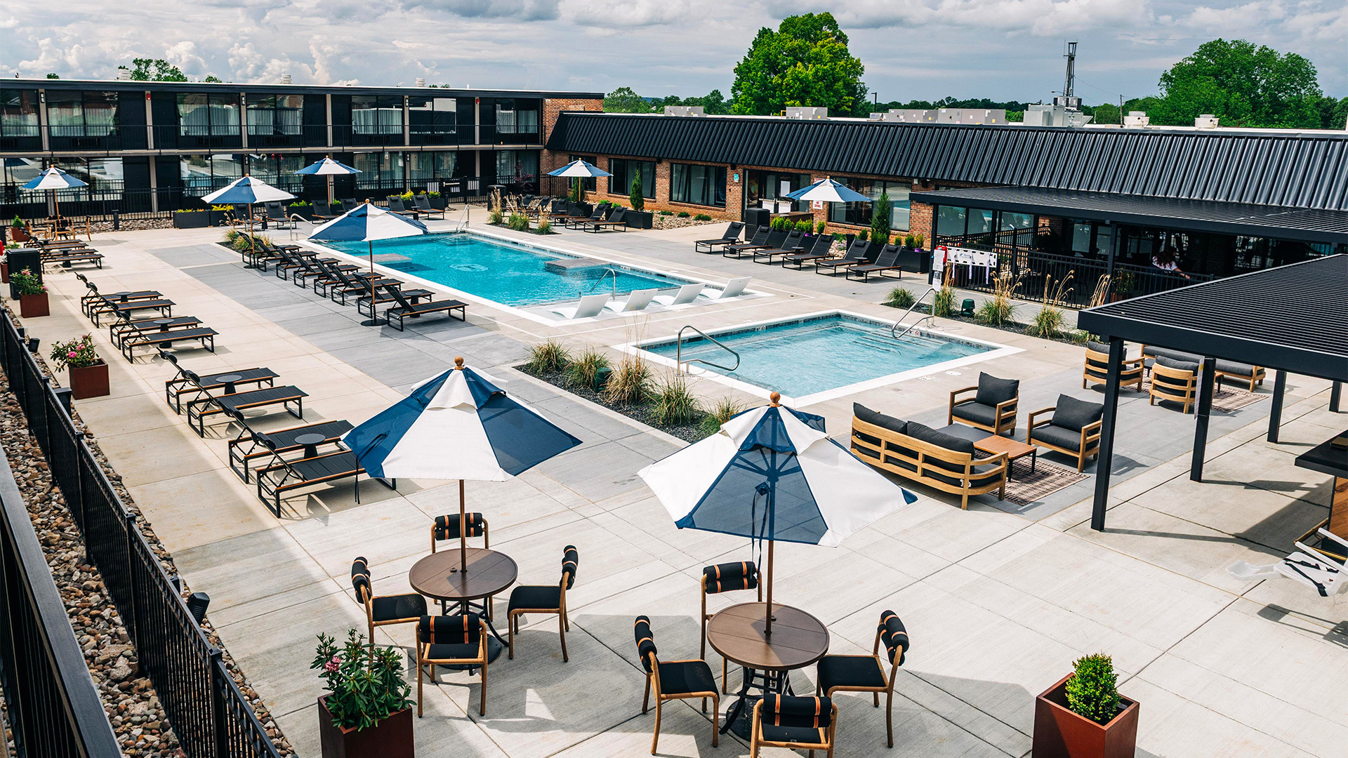 a pool with chairs and umbrellas