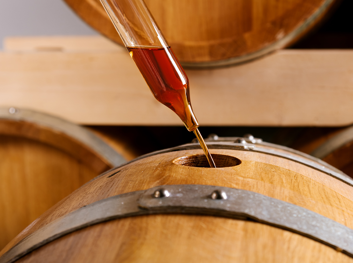 a pipette dropping liquid into a barrel