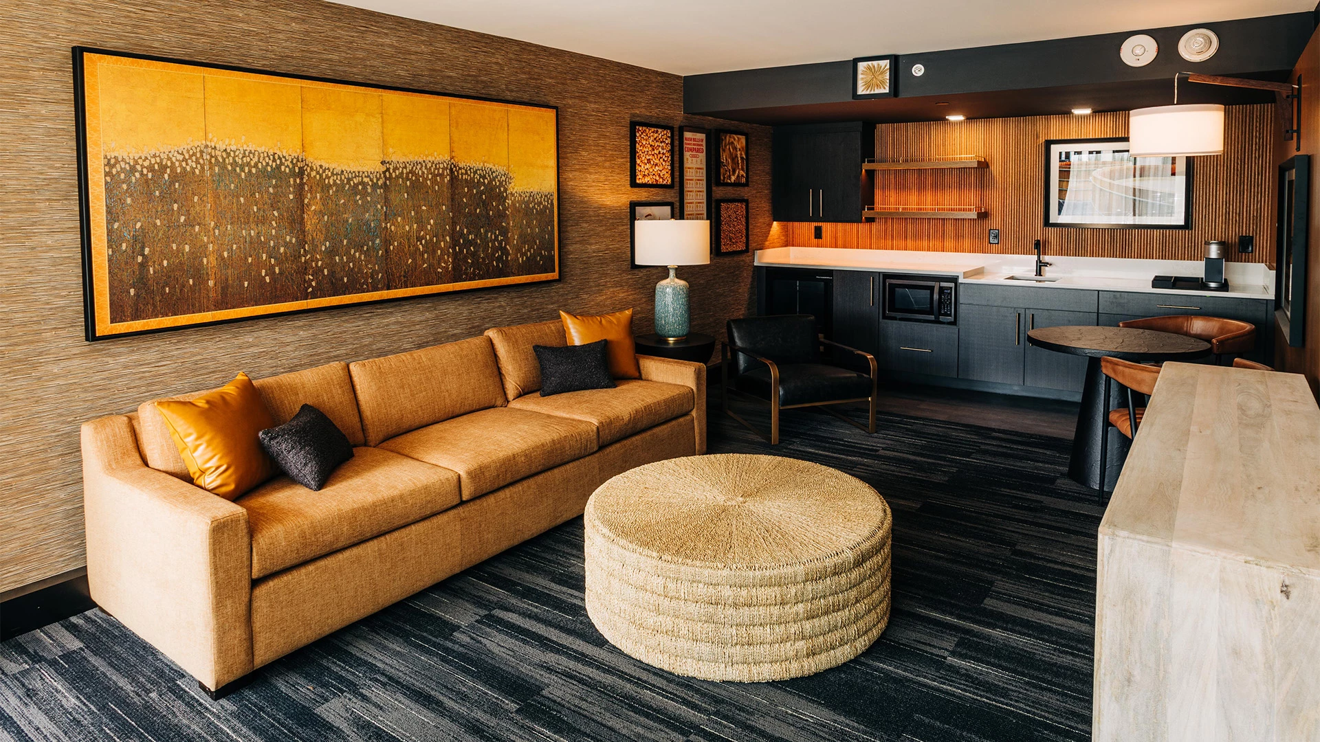 a living room with a couch and a stool