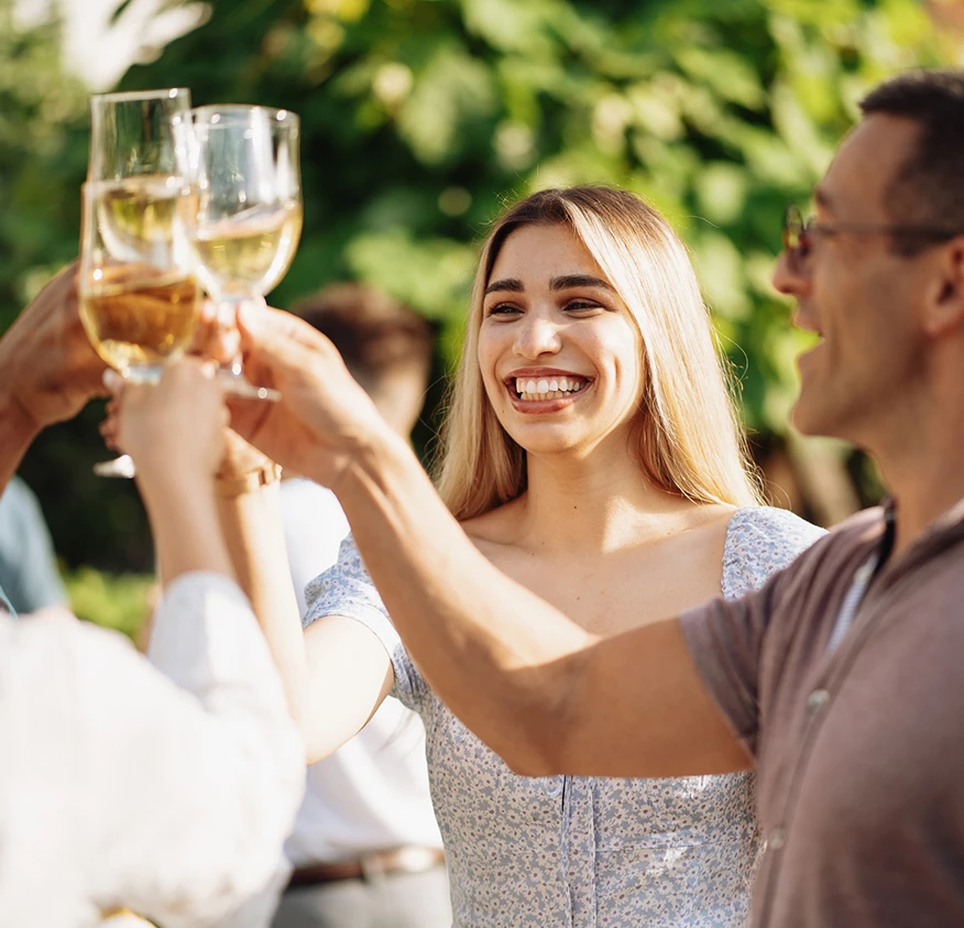 a group of people holding wine glasses