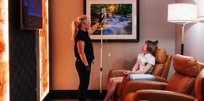 a woman in a room with a picture on the wall