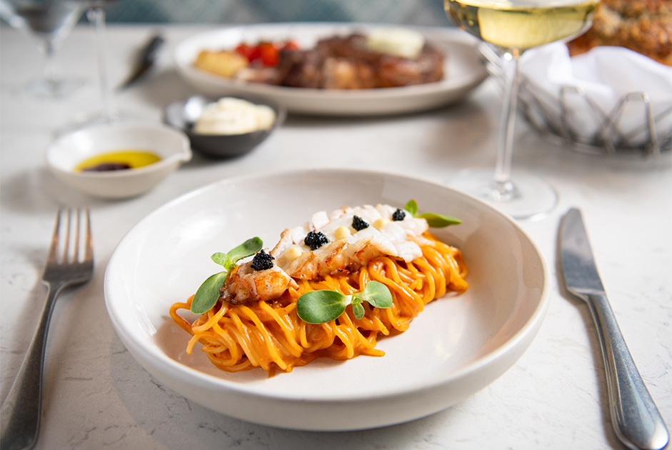 a plate of pasta with meat and vegetables
