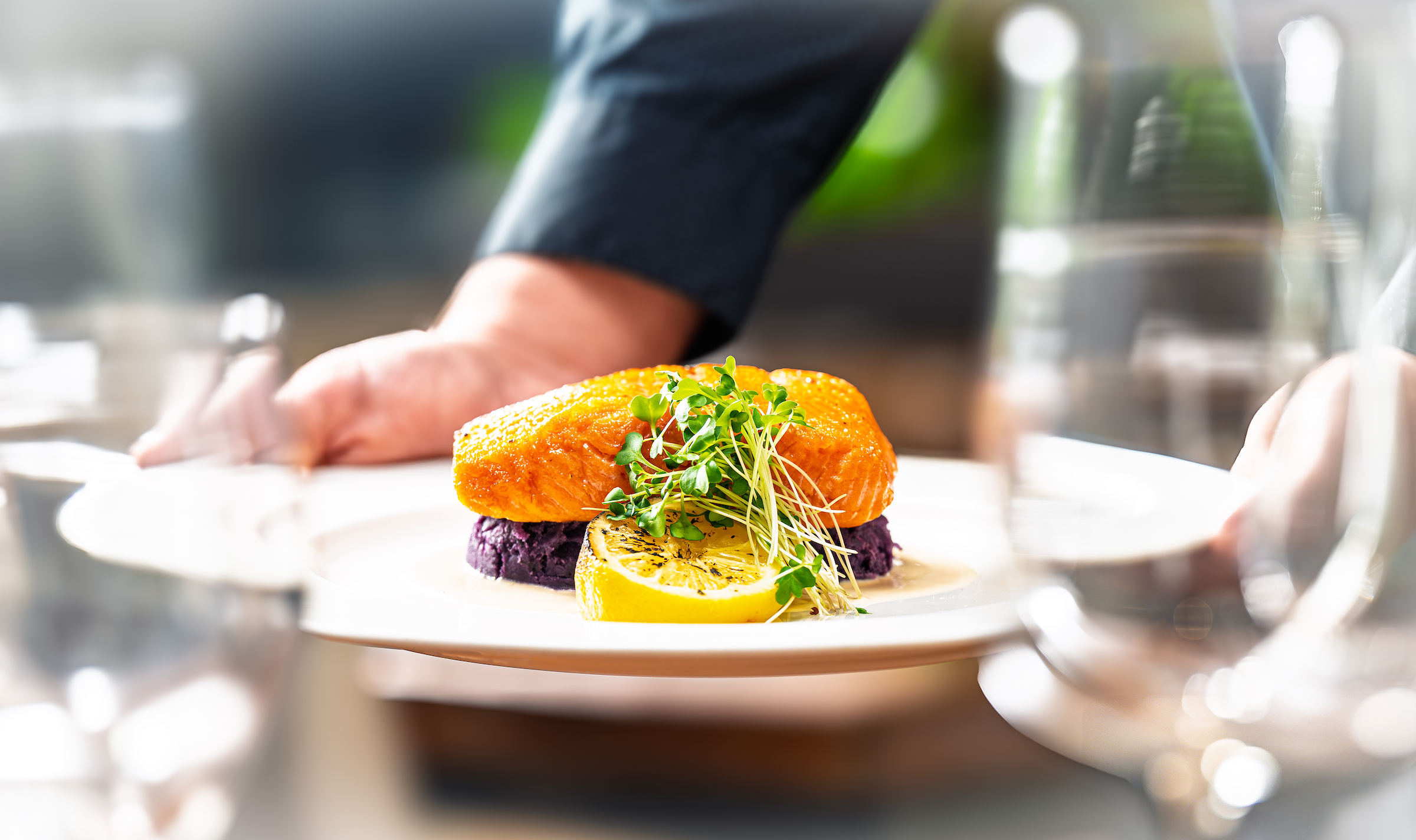 a plate of food with a lemon and sprouts