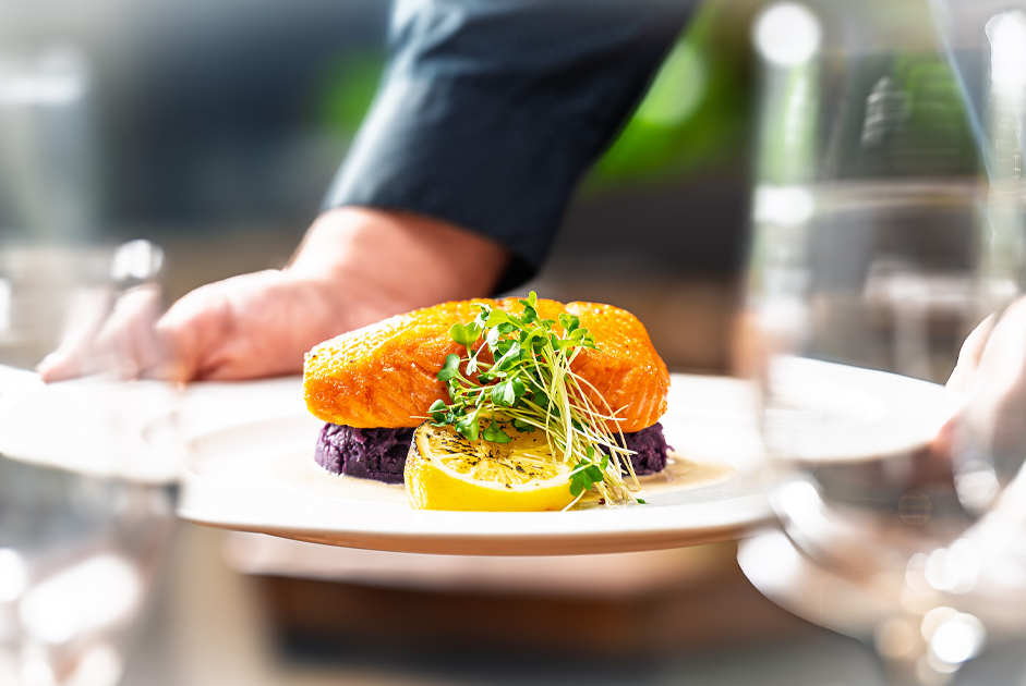 a plate of food with a lemon and sprouts