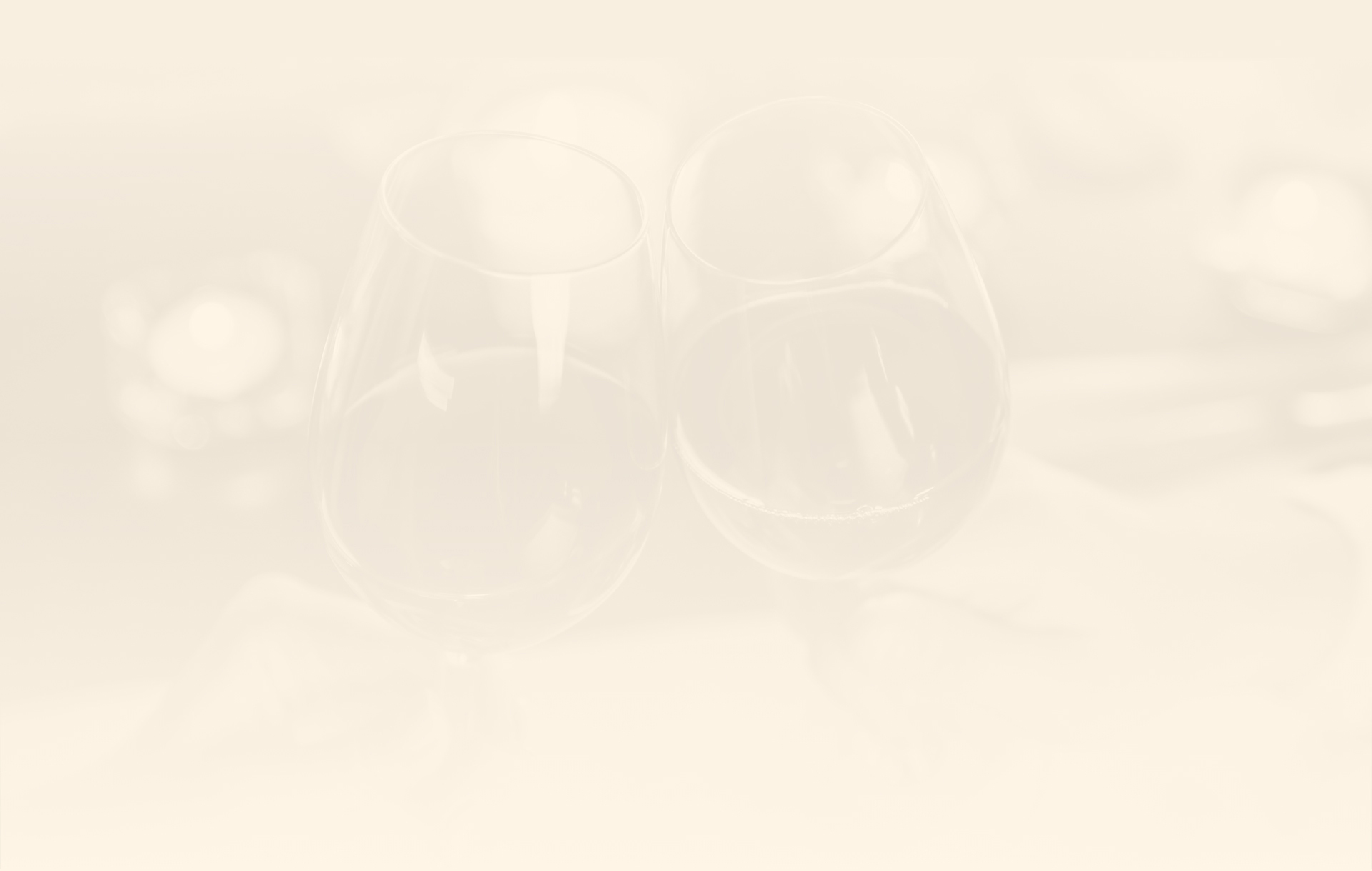 two glasses of wine on a white surface