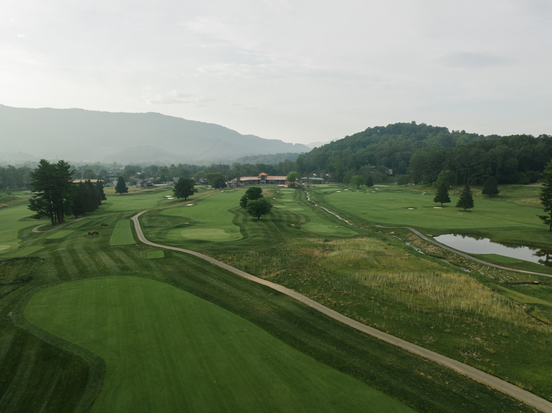 a golf course with a path and trees