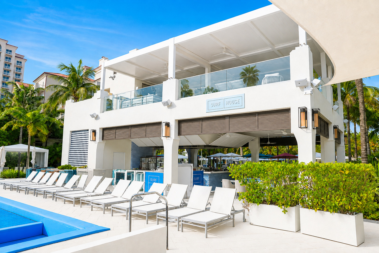 a pool and lounge chairs outside of a hotel
