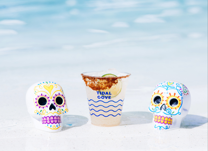 two skulls next to a drink