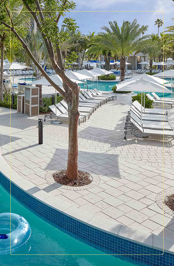 a pool with lounge chairs and umbrellas