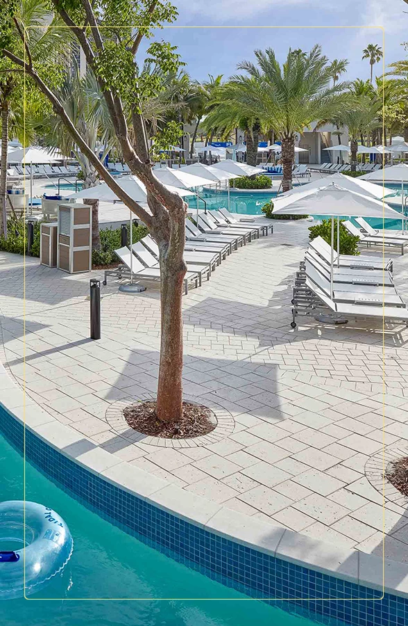 a pool with lounge chairs and umbrellas