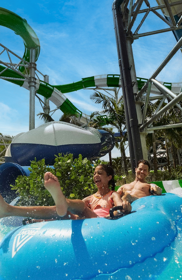 a man and woman on a water slide