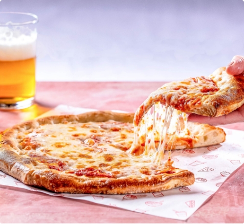 a hand holding a slice of pizza