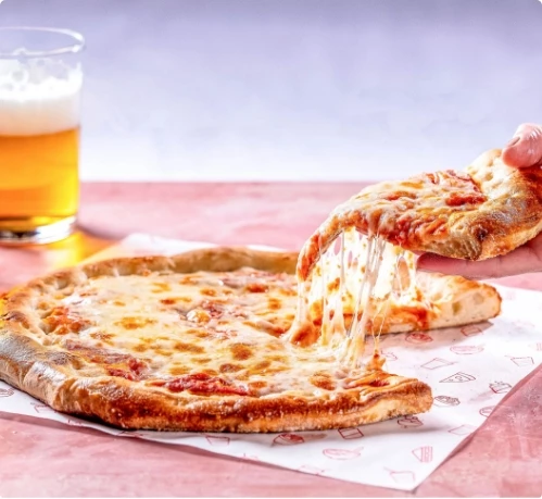 a hand holding a slice of pizza