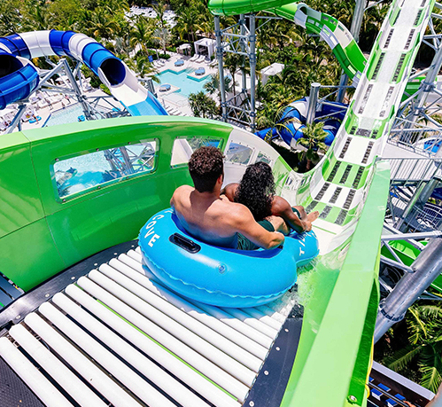 a man and woman on a water slide