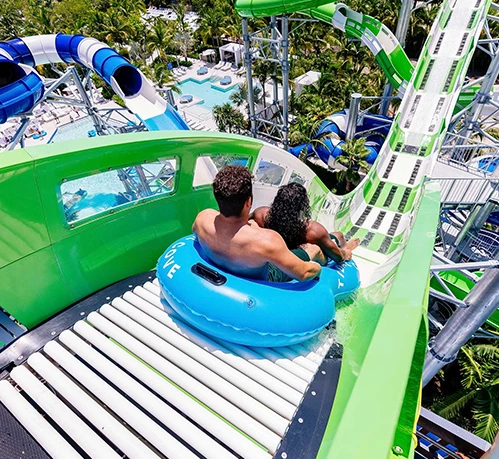 a man and woman on a water slide