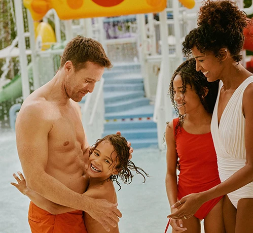 a man and woman holding a child