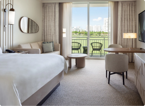 a room with a bed and a table and chairs