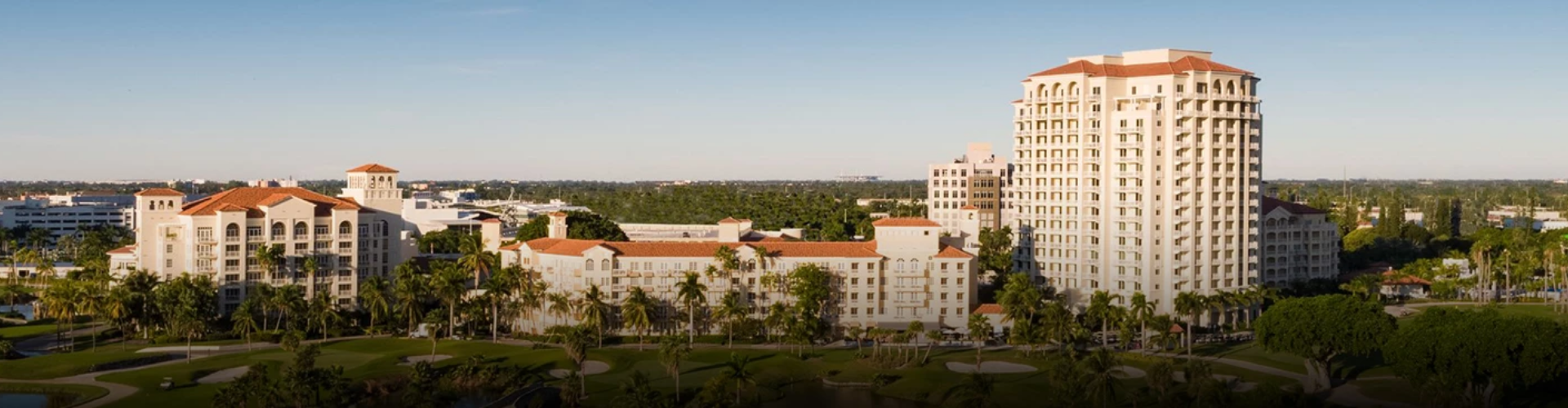 a large white building with palm trees