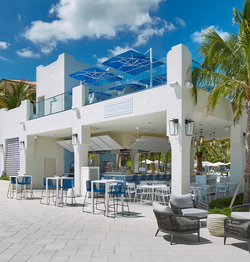 a white building with tables and chairs