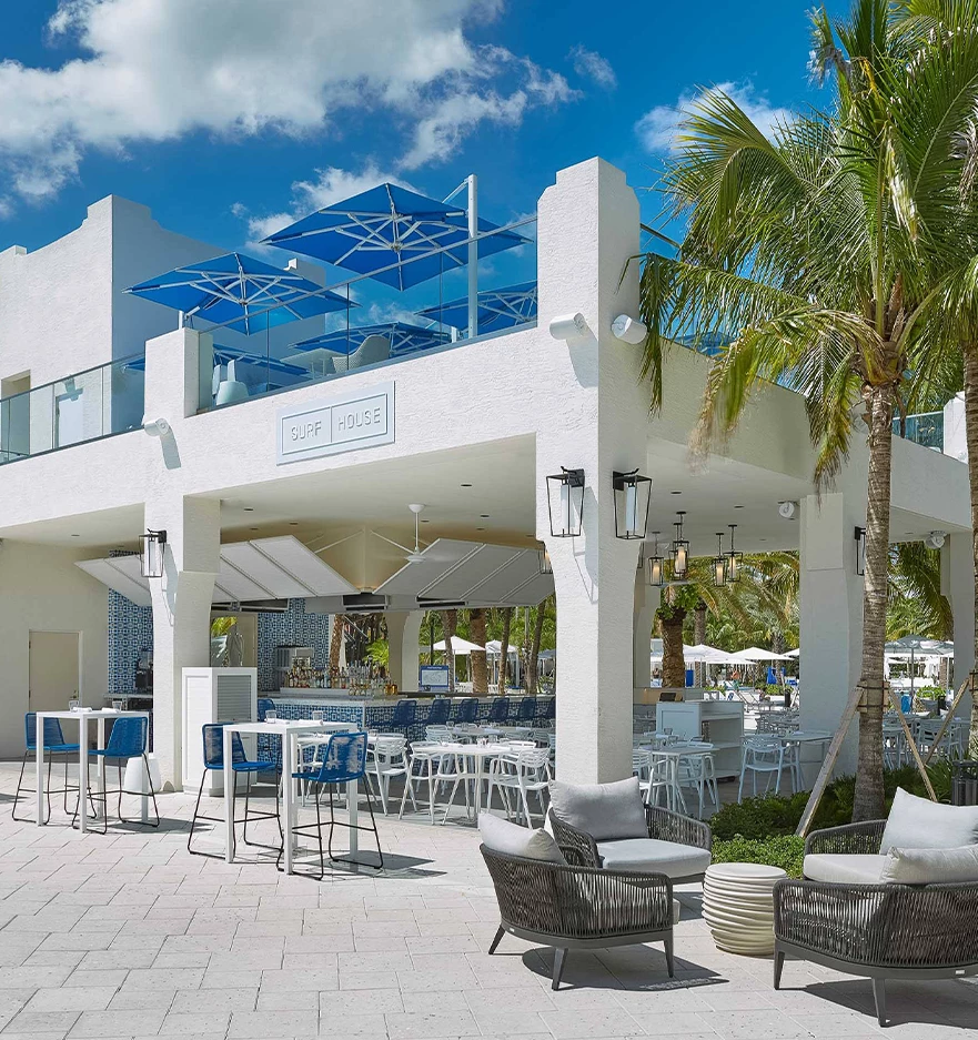 a white building with tables and chairs
