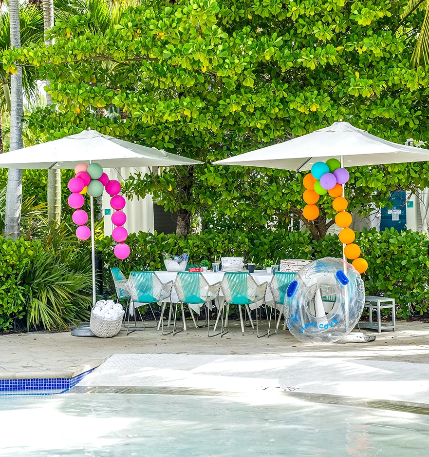 a table and chairs under umbrellas