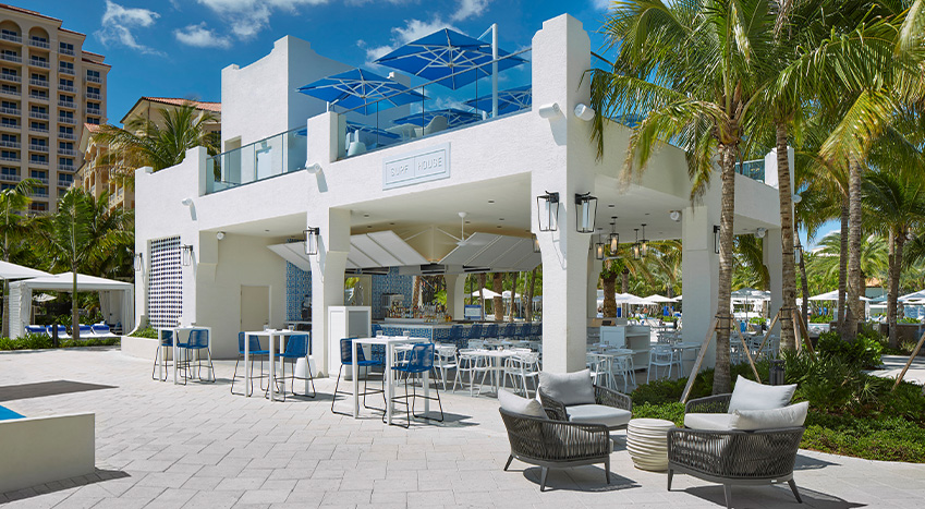 a white building with tables and chairs