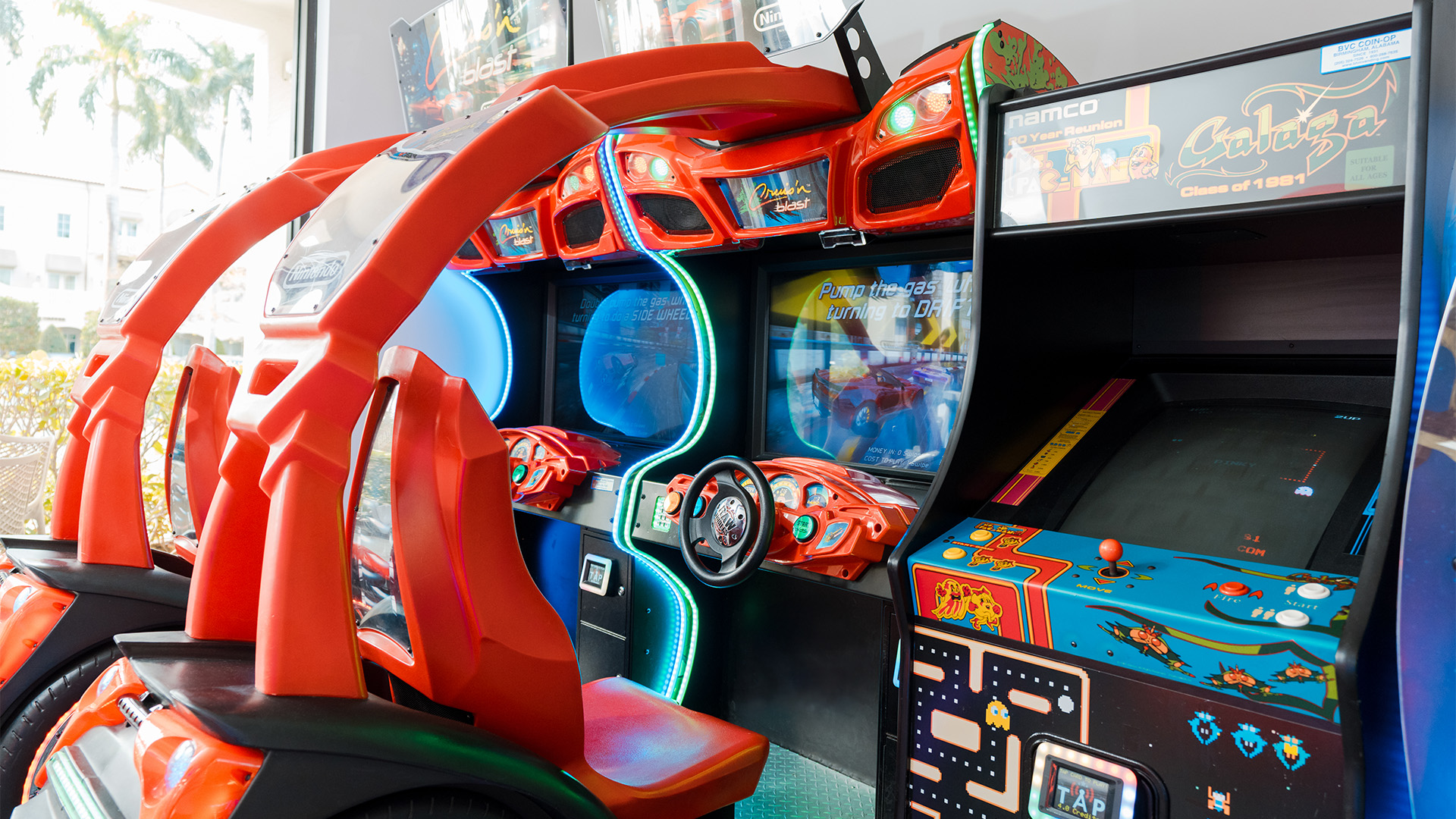 a video game machine with a steering wheel and a steering wheel