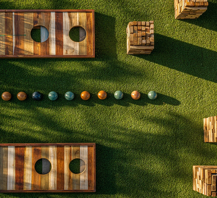 a game of bocce balls and wood blocks on grass
