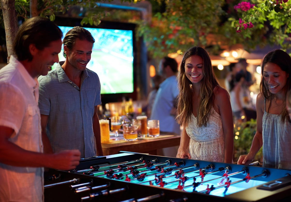 a group of people playing foosball