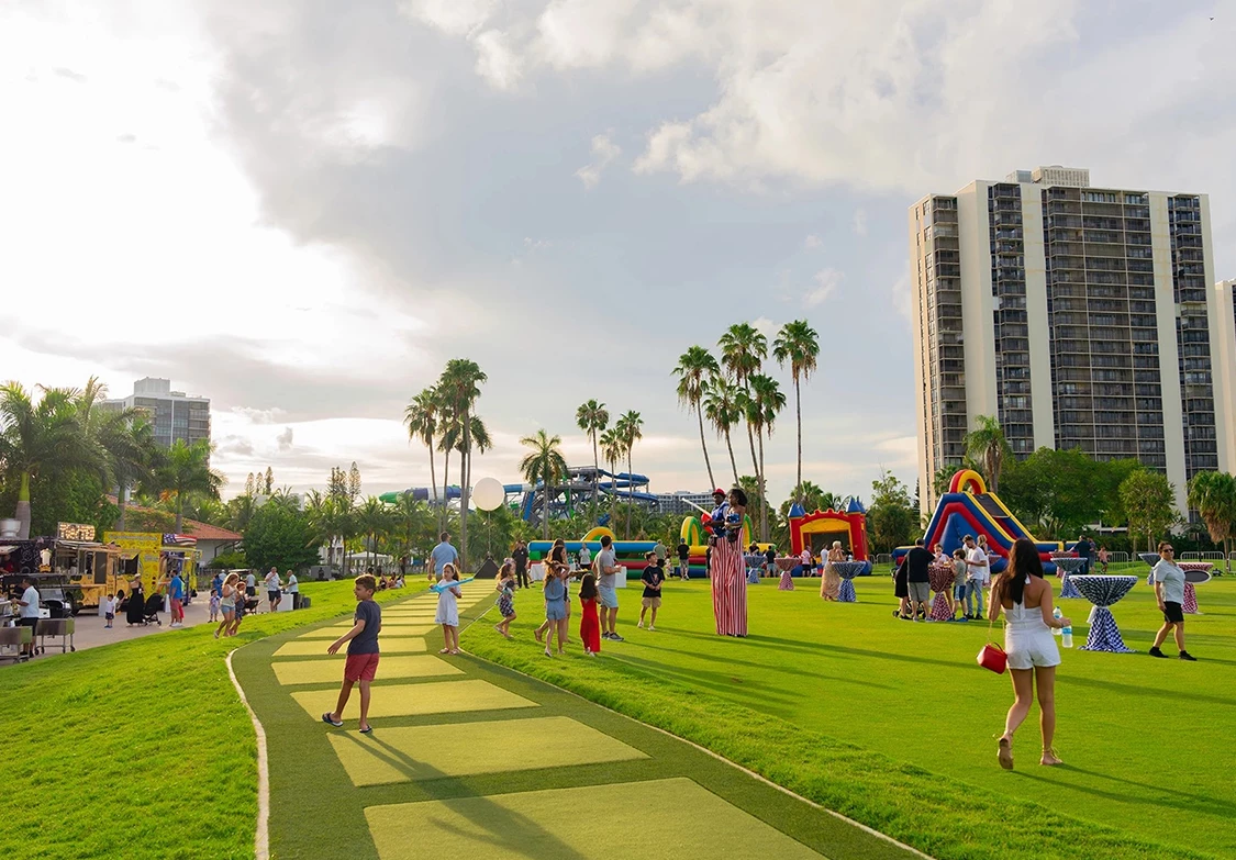 a group of people on a green path in a park