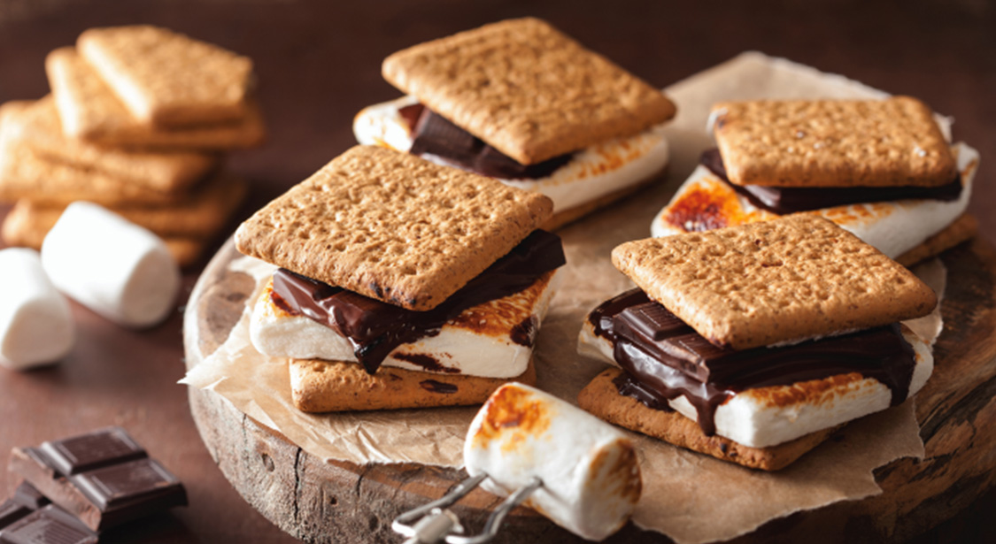 a group of smores on a wood surface