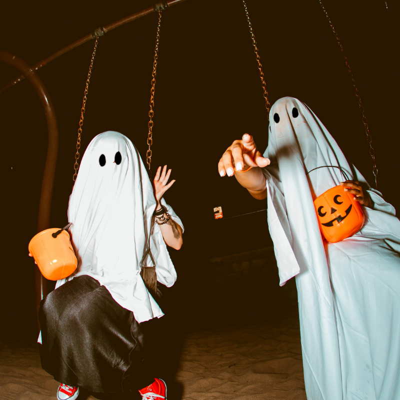 two people wearing clothing and holding buckets