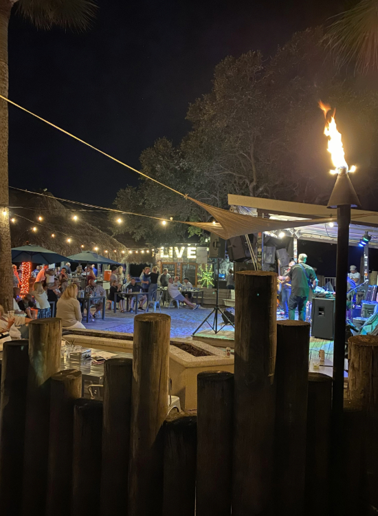 a group of people sitting around a fire torch