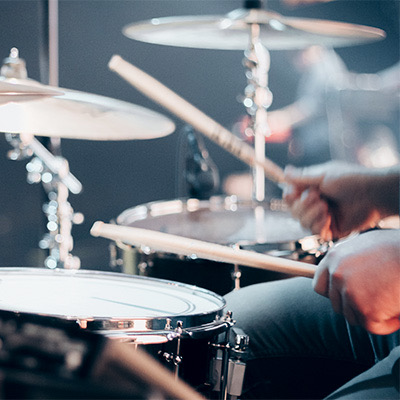 close up of someone playing the drums