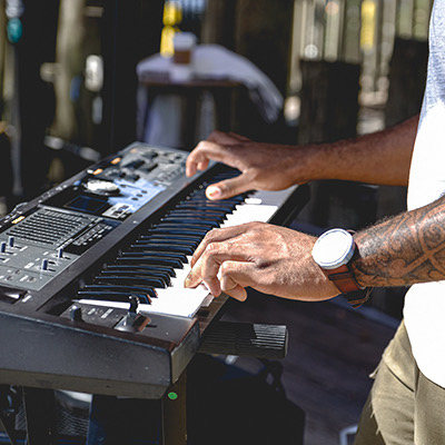 guy playing the keyboard on the Tiki Hut stage
