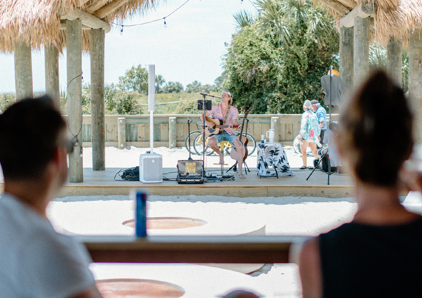 a man playing guitar on a stage