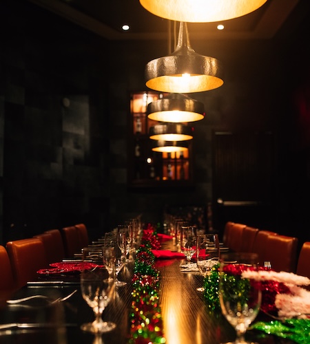 a long table with lights and glasses