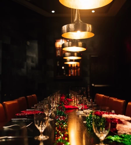 a long table with lights and glasses