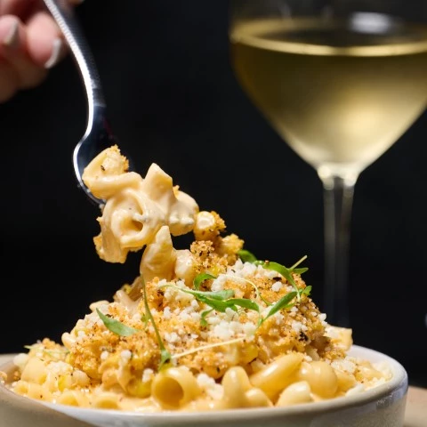 a bowl of macaroni and cheese with a fork