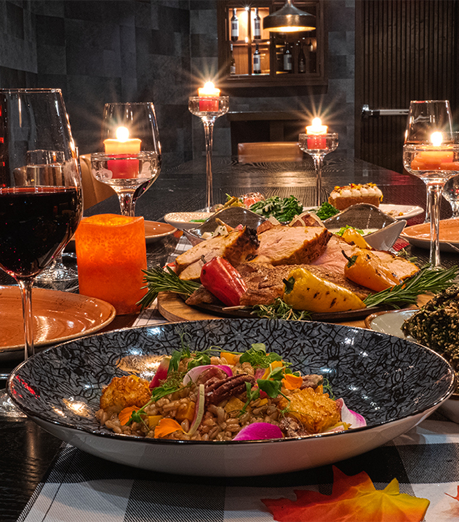 a table with food and wine glasses