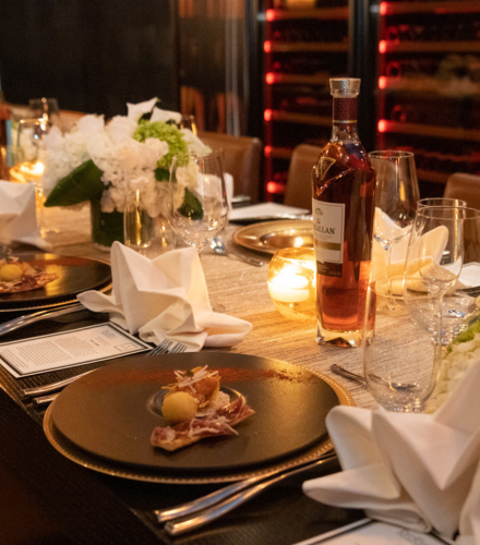 a table with plates and glasses and a bottle of wine