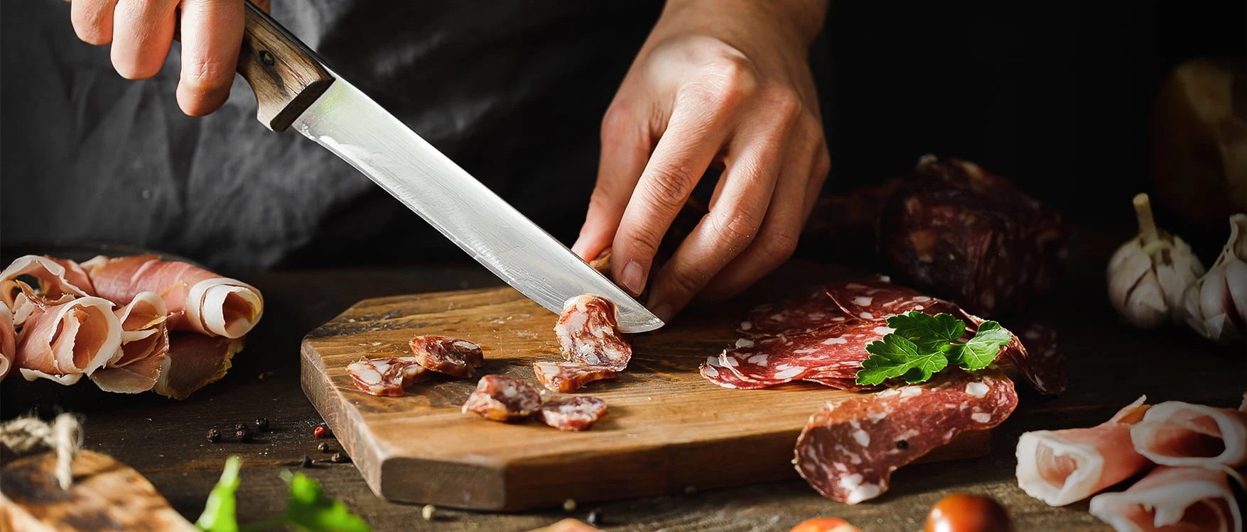 a person cutting meat with a knife