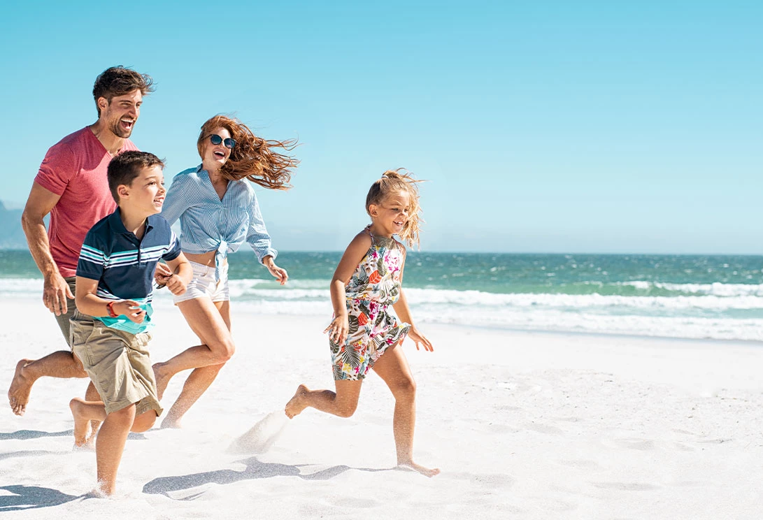 family running on the beach
