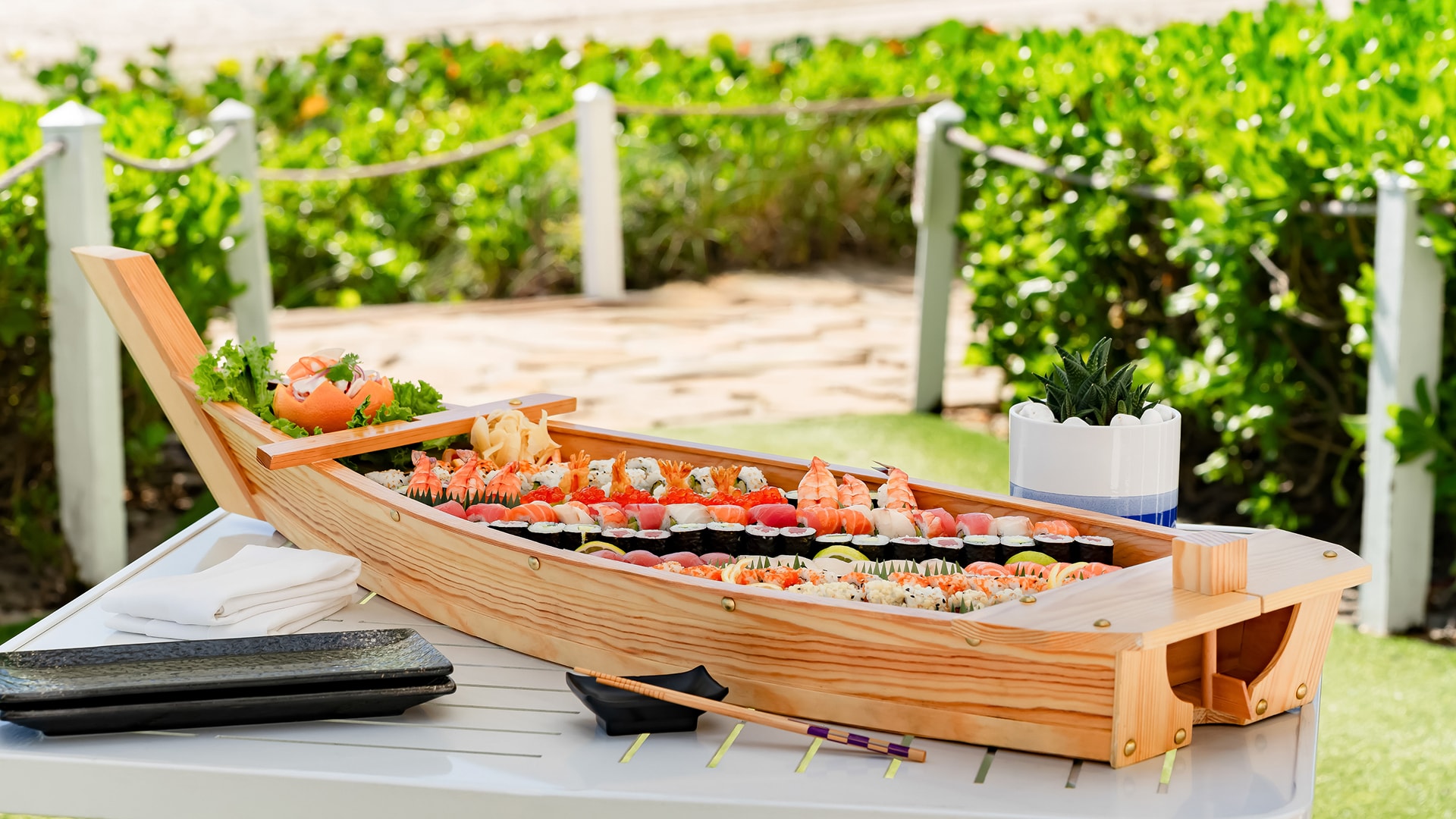 a wooden boat with sushi on it
