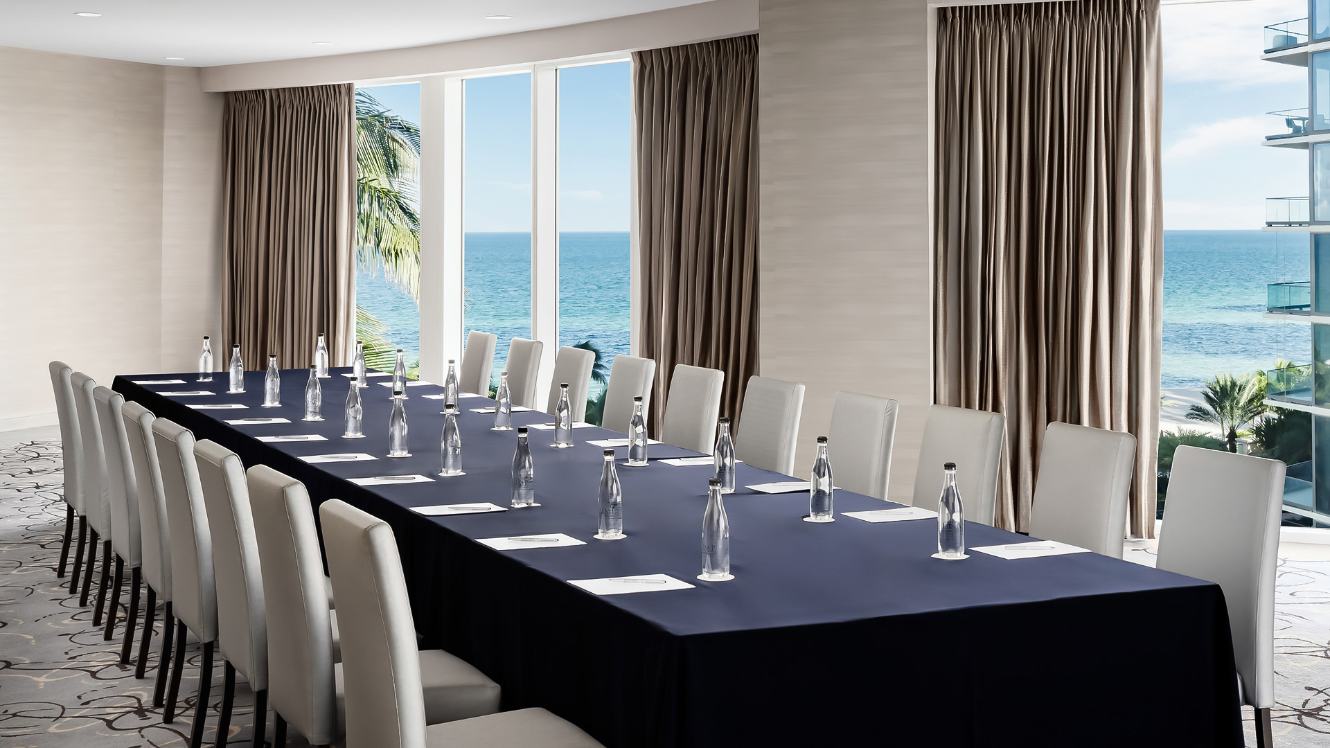 a long table with chairs and bottles on it