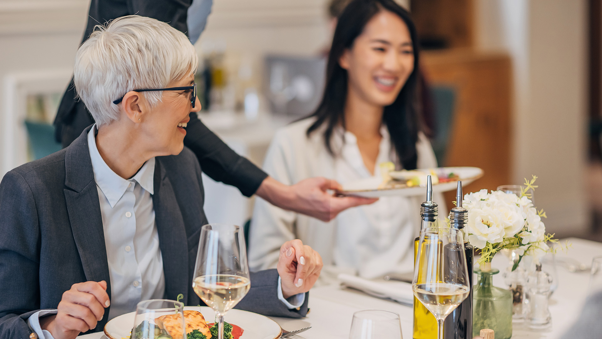 a woman serving food to a woman