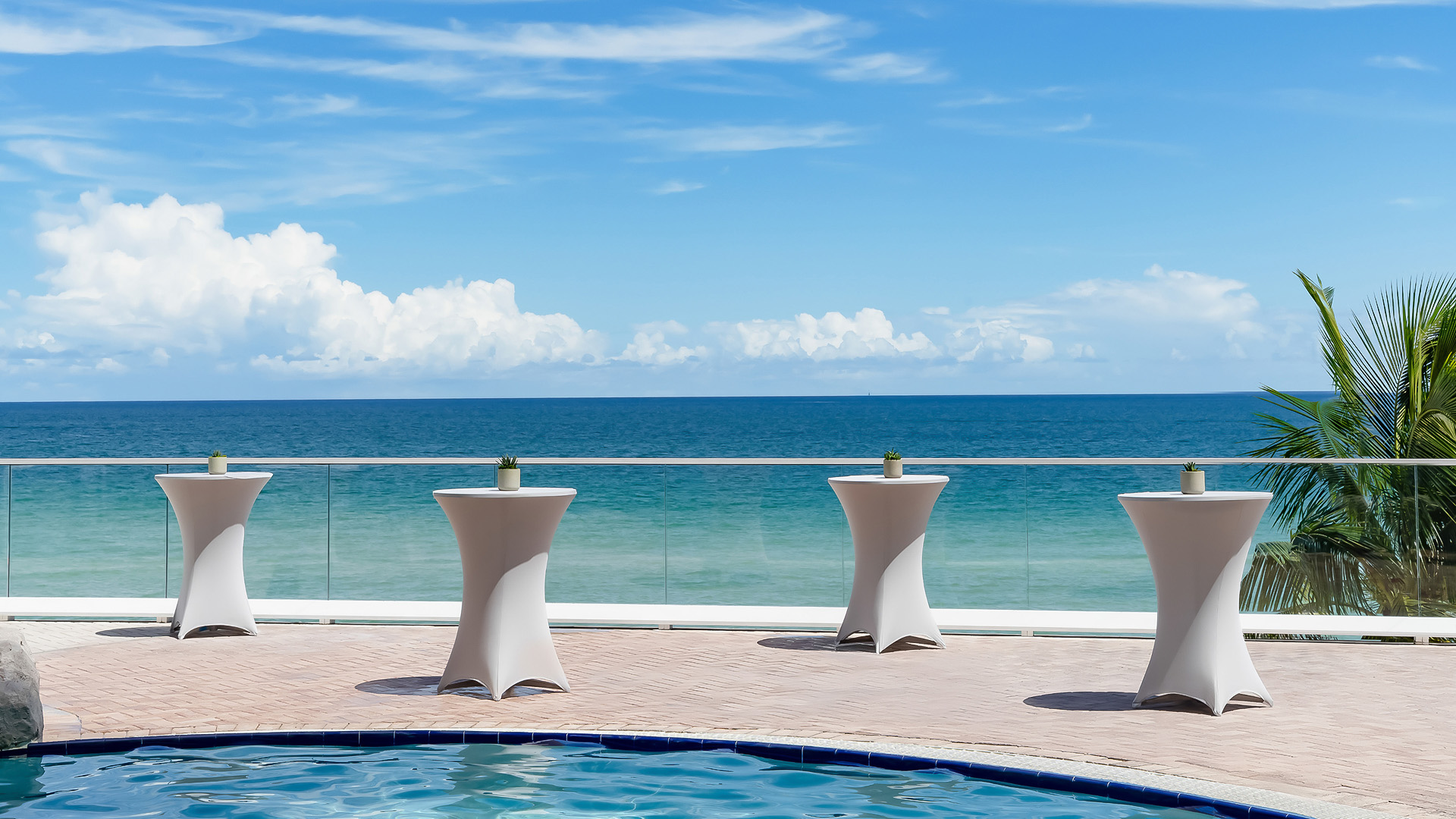 a pool with tables and chairs on it