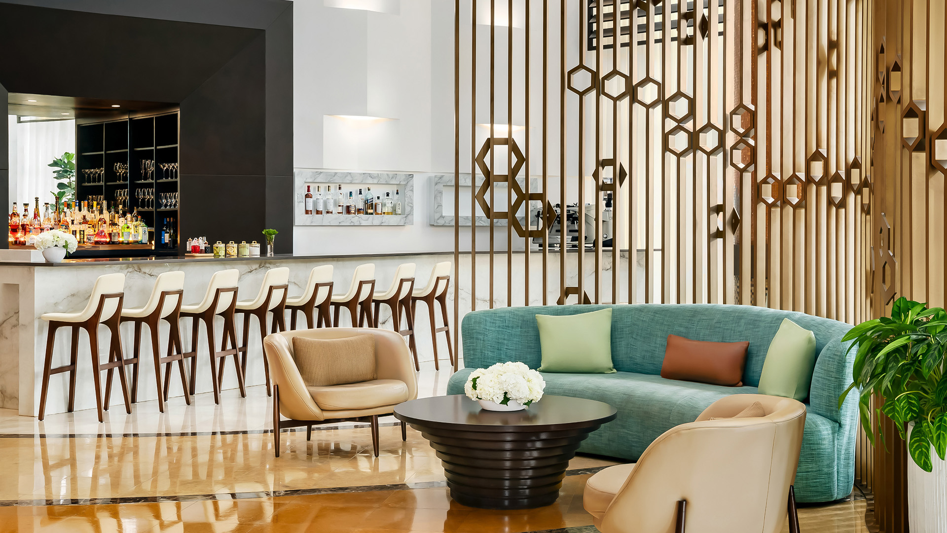 a room with a couch and chairs