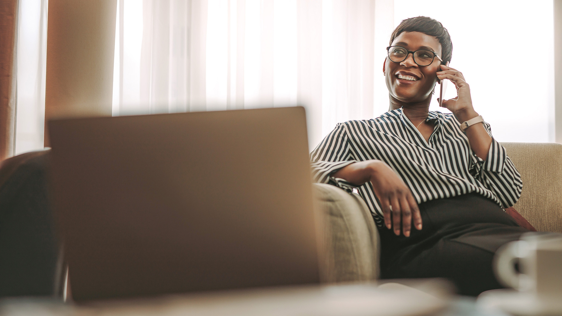 a woman sitting on a couch with a laptop